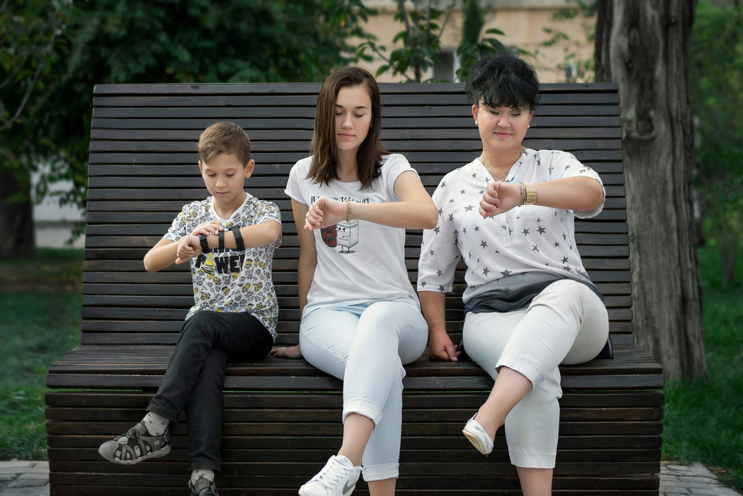 man and woman sitting on brown wooden bench